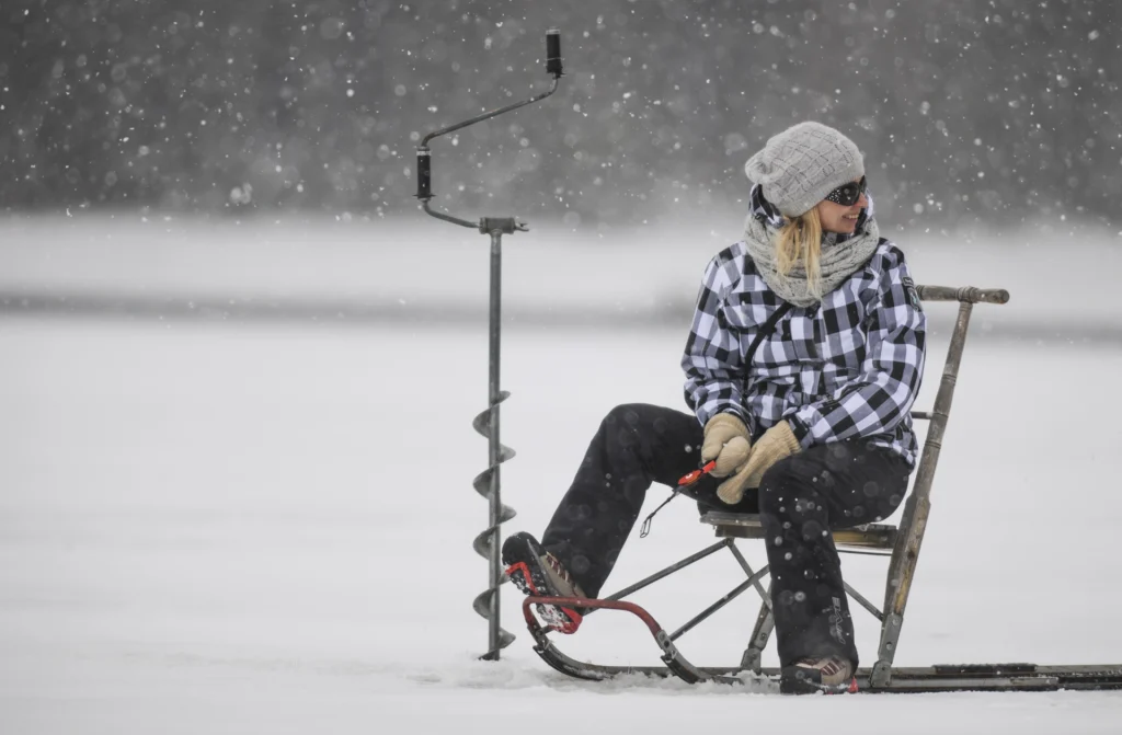 woman ice fishing on a lake